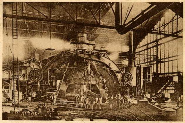 Ein Schwarz-Weiß-Foto einer Fabrikszene in der Cadillac Steel Works, das Menschen bei der Bedienung einer großen Maschine zeigt, umgeben von Leitern, Stangen und anderen Geräten.