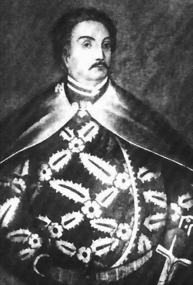 Schwarzes und weißes Foto von Papst Johannes Paul II. in Priesterrobe, der eine schwarze Robe mit weißem Kragen und Manschetten trägt und die Hände verschränkt hält, mit ernstem Gesichtsausdruck und direktem Blick.